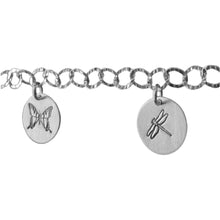 Sterling silver charm bracelet close-up photo.  Showcasing dragonfly and butterfly symbols.