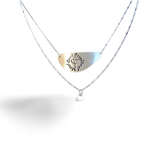Two layered necklace. Crescent shaped pendant with a sweet daughter of mine symbol and below it a heart pendant