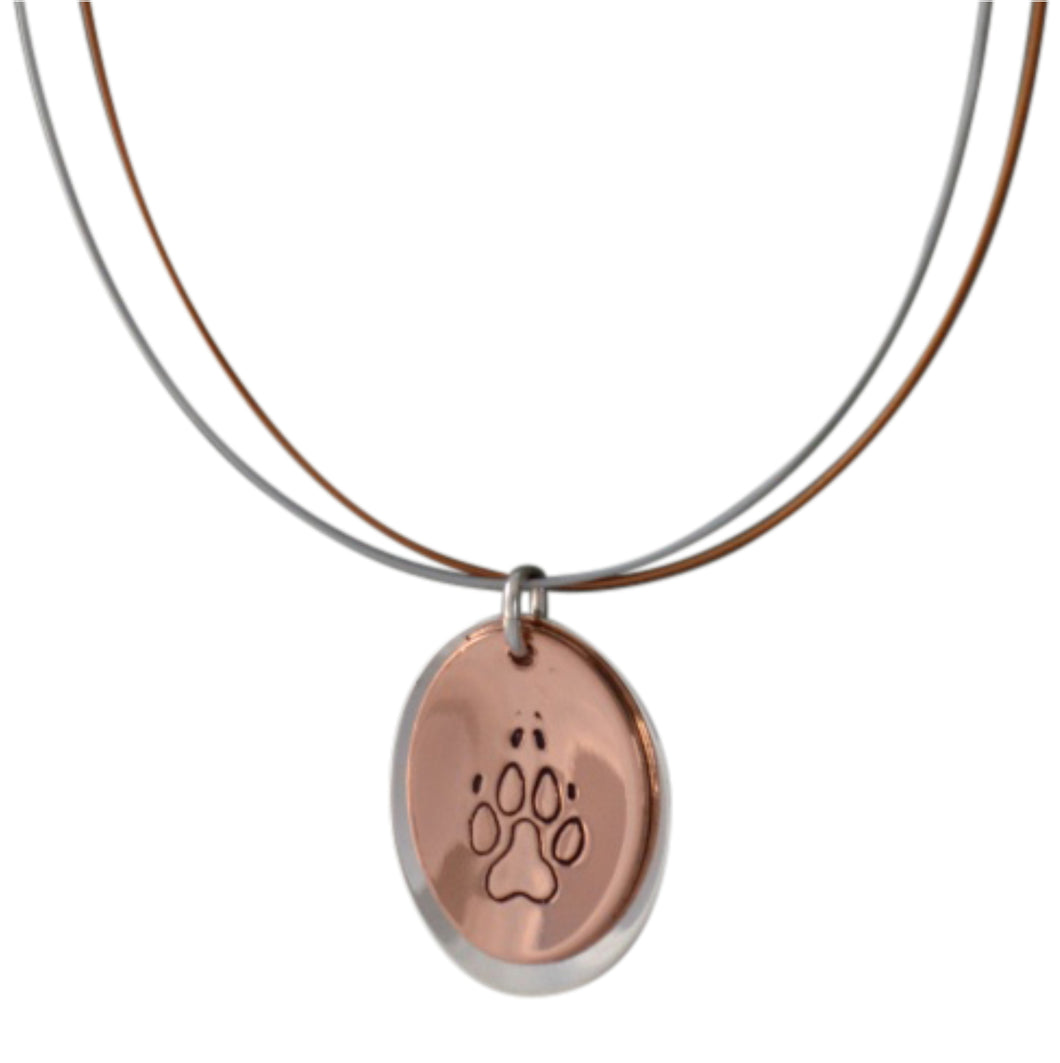 Copper and sterling silver oval necklace with Canadian symbols.  Dog paw print symbol pictured here.