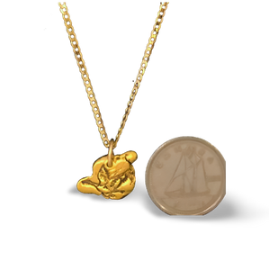 Canada Goose gold nugget pendant on 18" 10 karat gold chain. Shown beside a dime for scale.