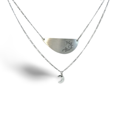 Layered silver necklace.  Top pendant has a harvest moon symbol on it and below hangs a mini crecent moon pendant.