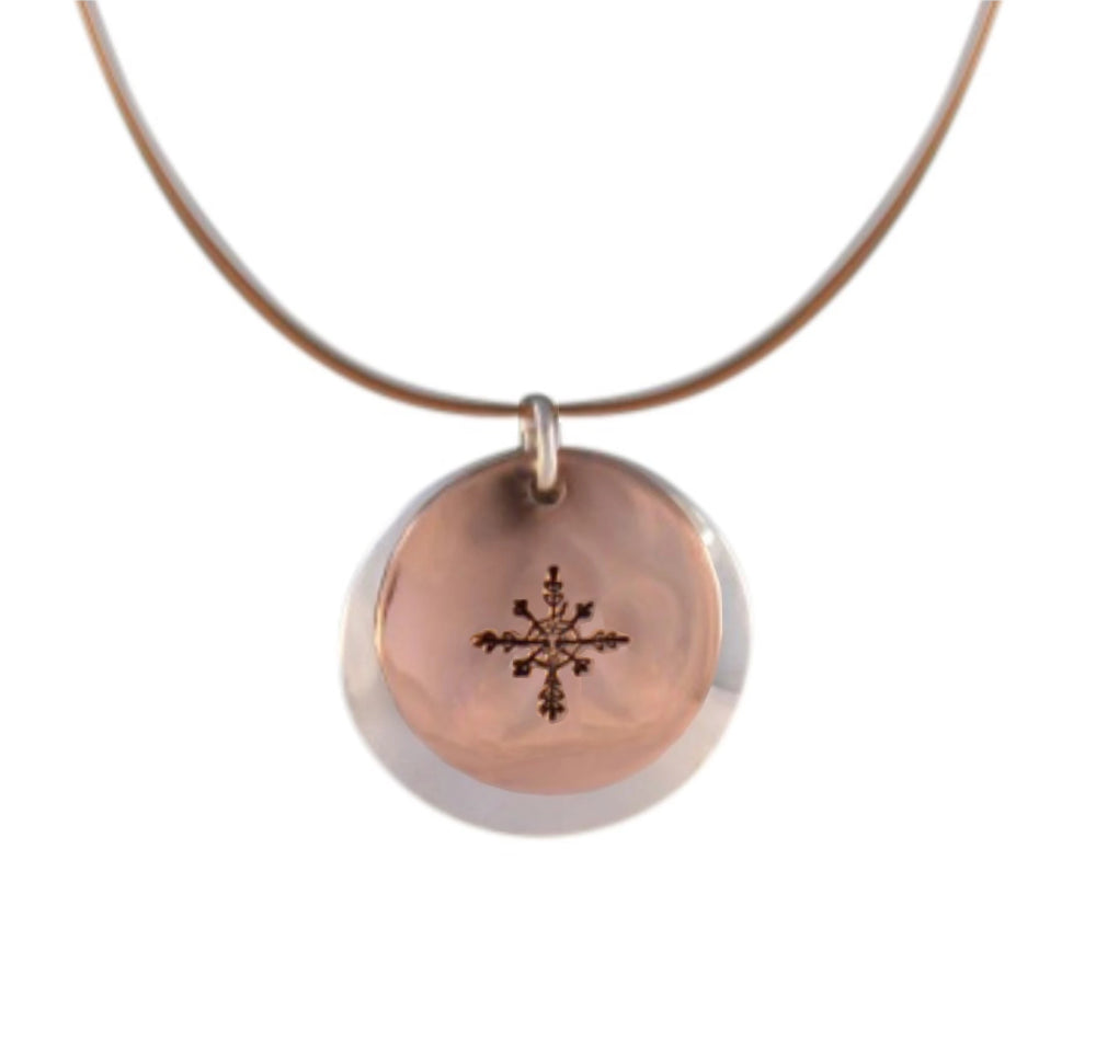 Copper and sterling silver round necklace with Canadian symbols.  Snowflake symbol pictured here.