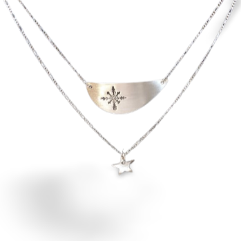 Two layered necklace.   Crescent shaped pendant with a snowflake and below it a star pendant..