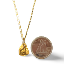 0.9 gr Wolf Gold Nugget Necklace beside a dime
