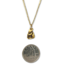 Gold nugget necklace with wolf symbol pictured with a Canadian Dime for proportions.